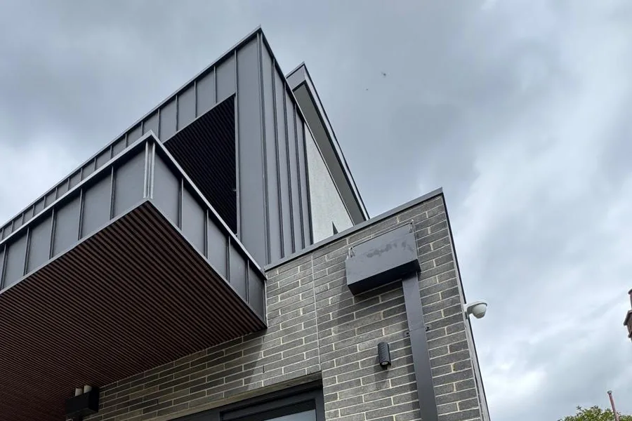 Two storey grey brick townhouse facade by DA Bricklaying