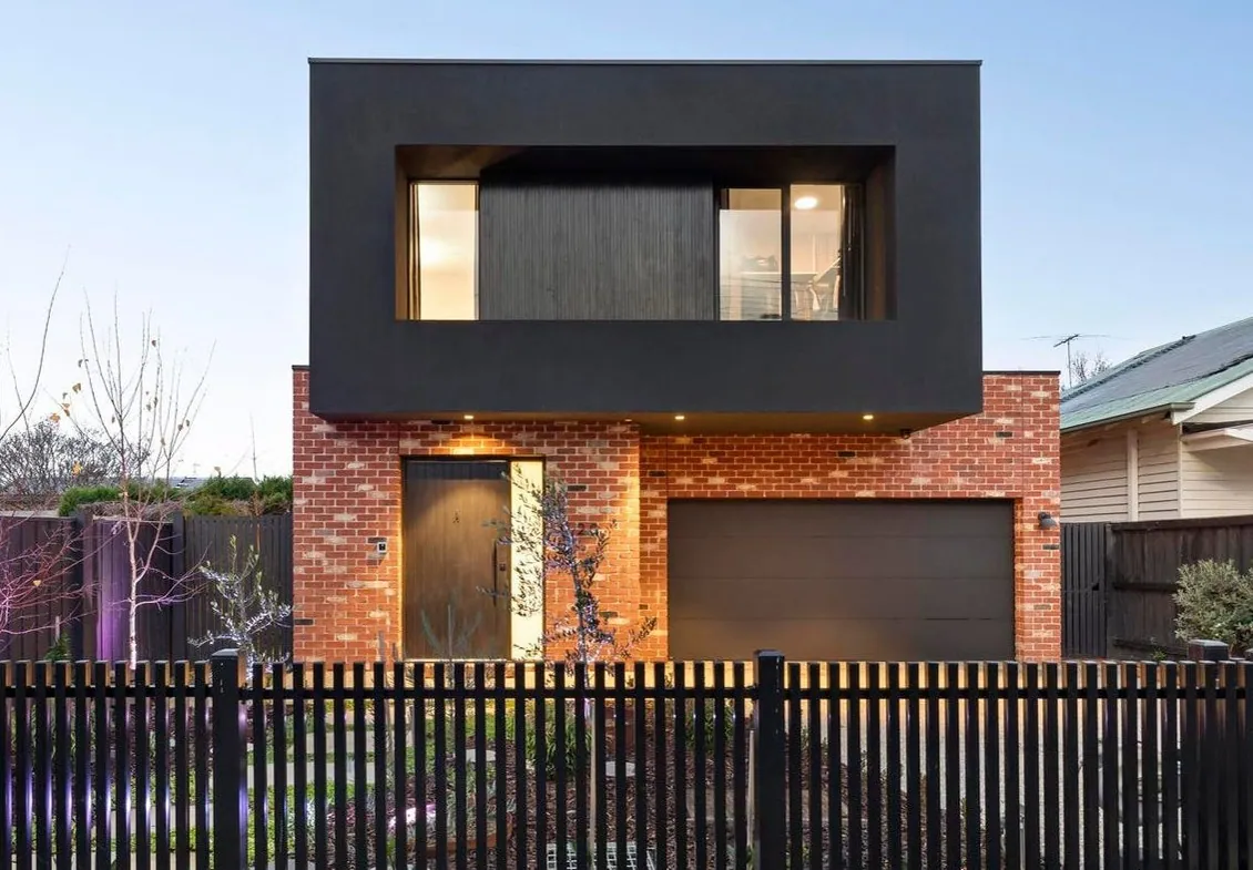 Red brick and black render architectural home